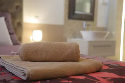 a towel is sitting on top of a bed at Vitez Apartment I in Ljubljana