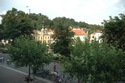 a view of a building with trees in front of it at Vitez Apartment I in Ljubljana