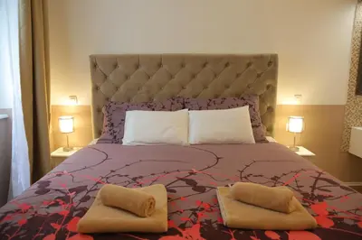 a bedroom with a large bed with two pillows on it at Vitez Apartment I in Ljubljana