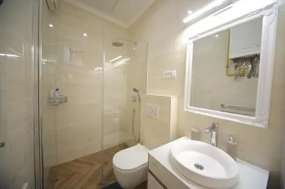 a bathroom with a toilet and a sink and a shower at Vitez Apartment I in Ljubljana