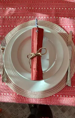 a plate with a red napkin on a table at Rooms Ravnik in Bled