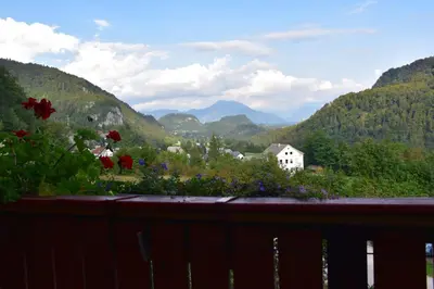 a balcony with a view of a valley with mountains at Rooms Ravnik in Bled