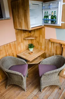 a kitchen with two chairs and a table and a refrigerator at Miškar Rooms in Cerknica