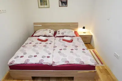 a bed in a small room with two pillows at Jacobs Resort 4 Bedroom Private House in Kranjska Gora