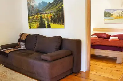 a living room with a couch and a bed at Jacobs Resort 4 Bedroom Private House in Kranjska Gora