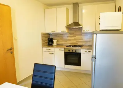 a kitchen with white cabinets and a refrigerator at Jacobs Resort 4 Bedroom Private House in Kranjska Gora