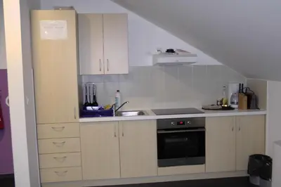 a kitchen with a sink and a stove at Youth Hostel Krško in Krško