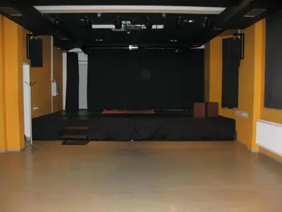 a stage with a black backdrop in a room at Youth Hostel Krško in Krško