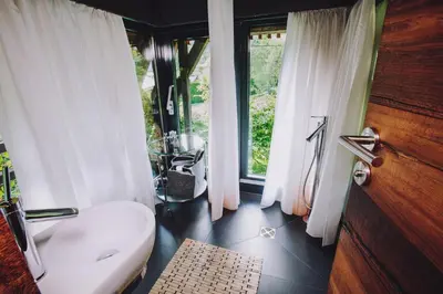 a bathroom with a toilet and a window at House Raduha in Luče