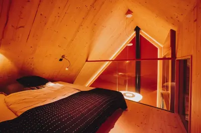 a bedroom with a bed in a room with a window at House Raduha in Luče