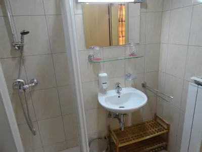 a bathroom with a sink and a shower at Rooms K in Maribor