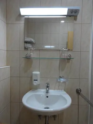 a bathroom with a sink and a mirror at Rooms K in Maribor