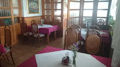 a restaurant with tables and chairs with purple table cloth at Rooms K in Maribor
