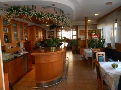 a restaurant with a bar in the middle of a room at Rooms K in Maribor