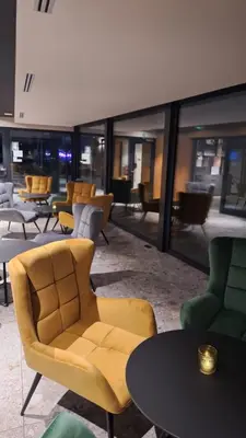 a lobby with chairs and tables in a building at Boutique & Wellness Hotel Vital in Moravske Toplice