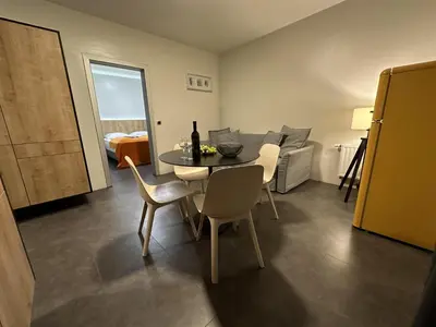 a living room with a table and chairs and a couch at Boutique & Wellness Hotel Vital in Moravske Toplice
