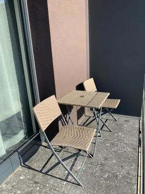 two chairs and a table and a table and chairs at Boutique & Wellness Hotel Vital in Moravske Toplice