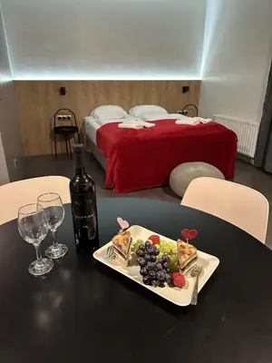a plate of food on a table with a bed at Boutique & Wellness Hotel Vital in Moravske Toplice