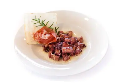 a white plate of food with meat and vegetables at Guesthouse Ošterija in Branik