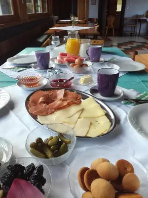 a table with many plates of food on it at Tourist Farm Ljubica in Poljane nad Škofjo Loko