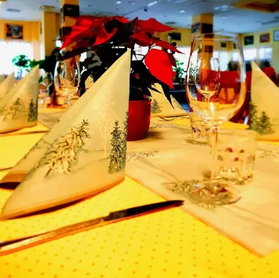 a table topped with yellow napkins and wine glasses at Hotel Galaksija Trebnje in Trebnje