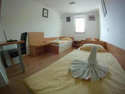a bedroom with a bed with a dress on it at Hotel Galaksija Trebnje in Trebnje