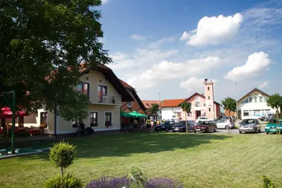 a small town with cars parked in a parking lot at Guest House Pri Treh Lipah in Ptuj
