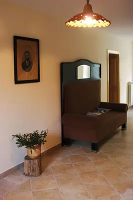 a living room with a couch and a picture on the wall at Apartments Janks in Vremski Britof