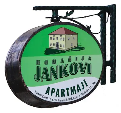 a sign for a tavern with a building on it at Apartments Janks in Vremski Britof