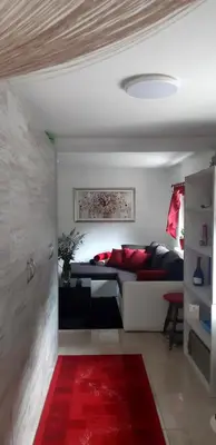 a bedroom with a bed and a red rug at Divine Lake House in Motnik