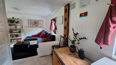 a living room with a couch and a table at Divine Lake House in Motnik