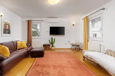 a living room with a couch and a flat screen tv at HoMEMADE in Ljubljana