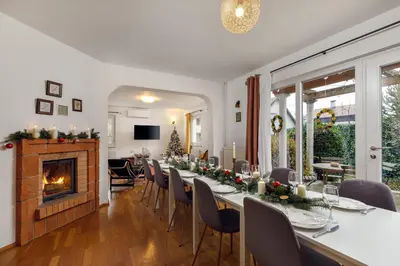 a dining room with a long table and a fireplace at HoMEMADE in Ljubljana