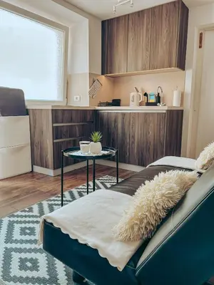 a living room with a couch and a table at Apartments Ivanović in Idrija