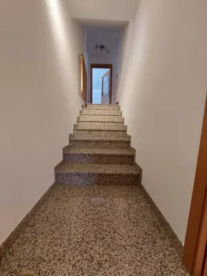 a stairway leading up to a room with a door at Apartma Teloh in Kopačnica