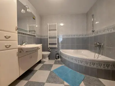 a bathroom with a tub and a toilet and a sink at Apartma Teloh in Kopačnica