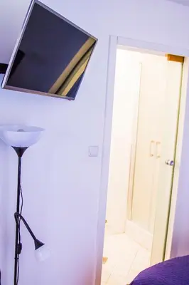 a flat screen tv on the wall of a bedroom at Apartment Baba Yaga 12 in Rogaška Slatina