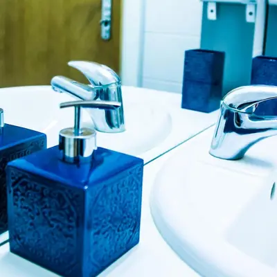 a bathroom with two sinks and a faucet at Apartment Baba Yaga 12 in Rogaška Slatina