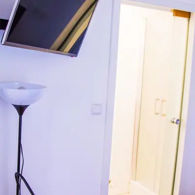 a mirror hanging on a wall next to a door at Apartment Baba Yaga 12 in Rogaška Slatina