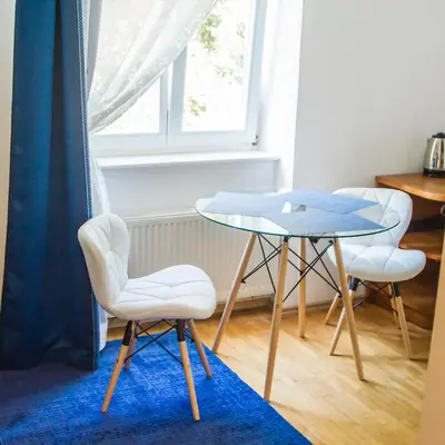 a table and two chairs and a table and a window at Apartment Baba Yaga 12 in Rogaška Slatina