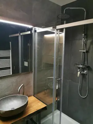 a bathroom with a sink and a glass shower at Hotel CityMap Maribor in Maribor
