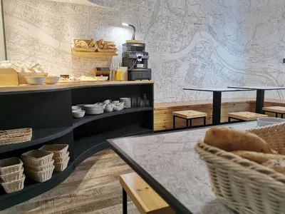 a bakery with tables and baskets on a wall at Hotel CityMap Maribor in Maribor