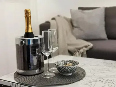 a bottle of champagne and glasses on a table at Hotel CityMap Maribor in Maribor