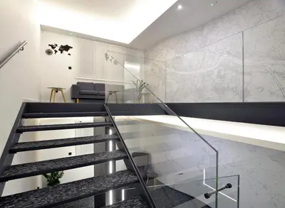 a glass staircase in a house with a living room at Hotel CityMap Maribor in Maribor