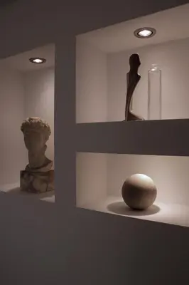 a vase and a statue on a shelf with a stone at Deluxe Apartments Panorama in Lesce