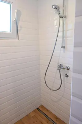 a shower with a shower head in a bathroom at Domačija KOHOVO in Lovrenc na Pohorju