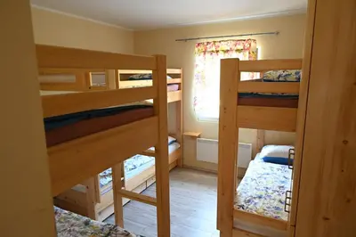 a room with three bunk beds and a window at Domačija KOHOVO in Lovrenc na Pohorju