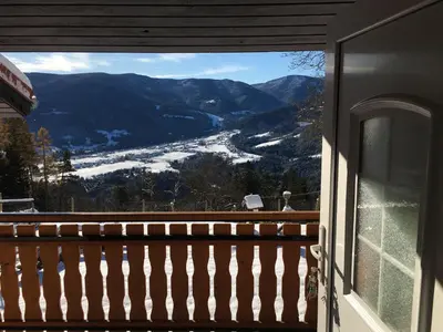 a view of a snowy mountain from a balcony at Domačija KOHOVO in Lovrenc na Pohorju
