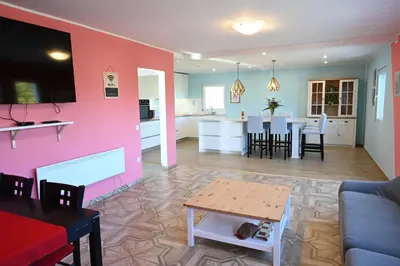a living room and kitchen with a table and chairs at Domačija KOHOVO in Lovrenc na Pohorju