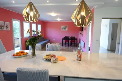 a kitchen and living room with a table with food and drinks at Domačija KOHOVO in Lovrenc na Pohorju